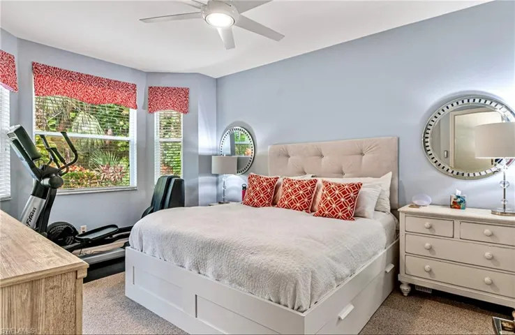 Bedroom with light carpet and ceiling fan