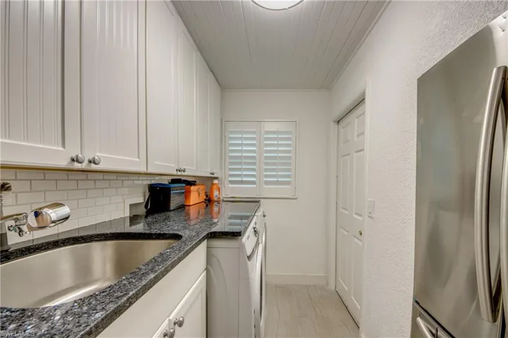 Laundry room with extra full-sized refrigerator