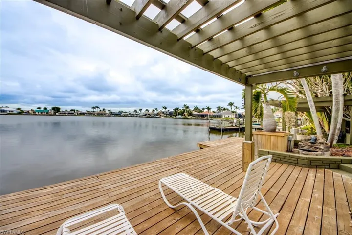 Dock area with a water view and a pergola