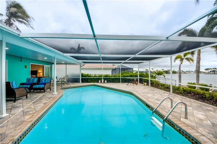 Outdoor pool featuring, a patio, and a water views