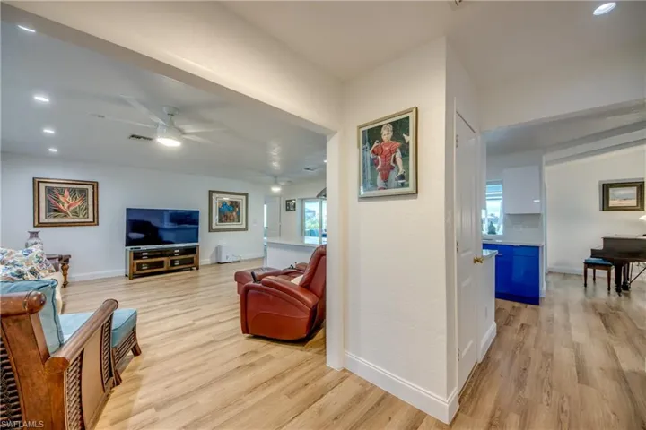 Living room featuring light wood-style LVP floors, and recessed lighting