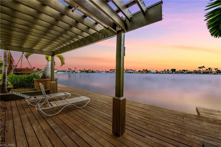 Dock area with a water view and a pergola