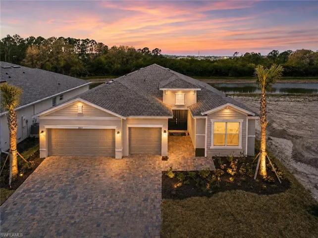 Contemporary single-story residence with a multi-car garage, paver driveway, and a covered entry
