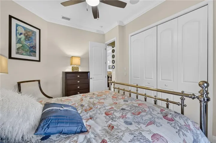 Guest bedroom 2 Room featuring crown molding, a ceiling fan, and bi-fold closet doors