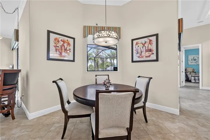 Dining area featuring a window, tile flooring, a decorative chandelier, and light-toned walls
