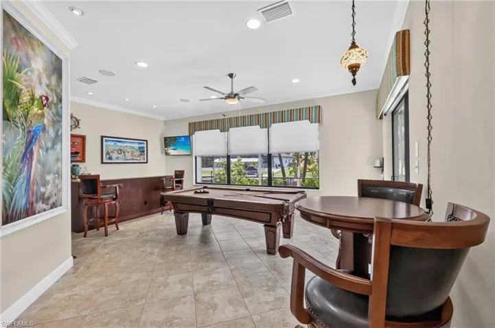 Recreation room featuring tiled flooring, built-in wet bar, recessed lighting, and a ceiling fan