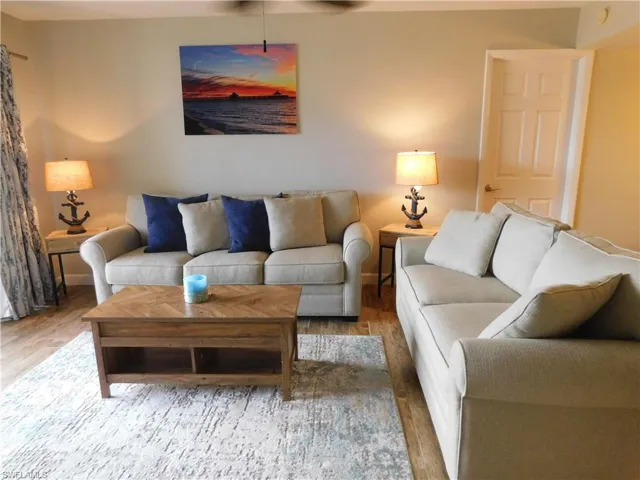 Living room with hardwood / wood-style flooring