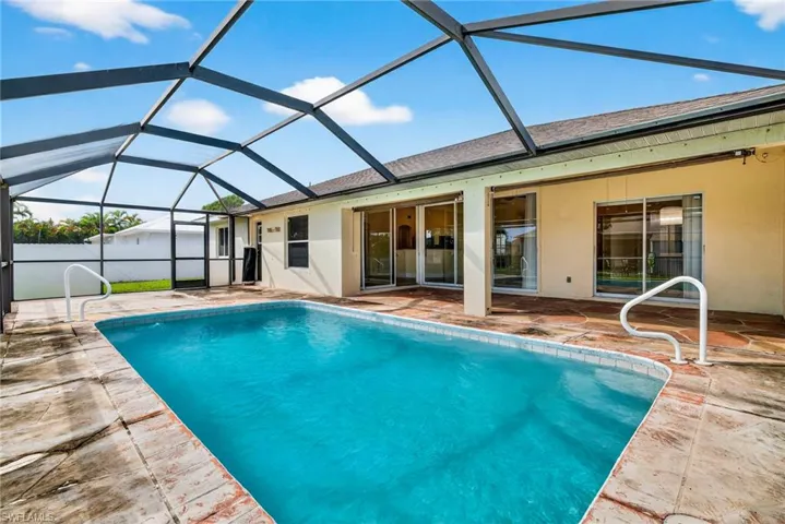 View of pool featuring a sunroom, a patio, and a lanai