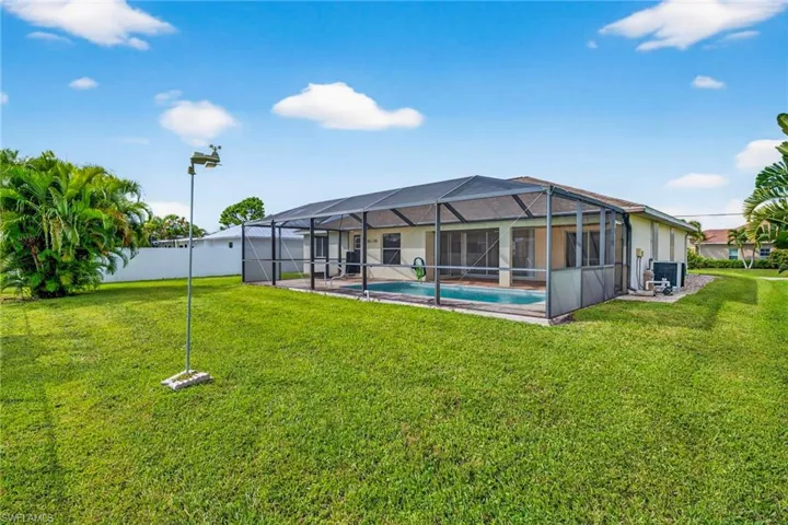 Rear view of property featuring a lanai, a sunroom, and a patio area