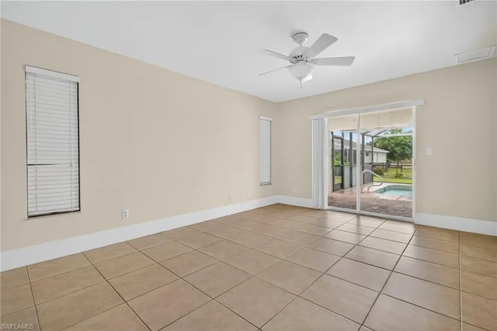 Spare room featuring light tile patterned flooring and ceiling fan