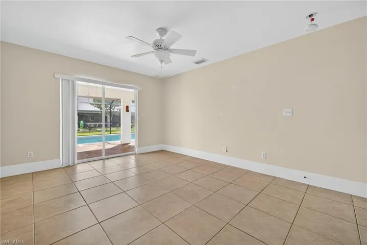 Unfurnished room featuring light tile patterned floors and ceiling fan