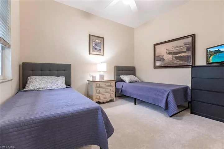 Carpeted bedroom with ceiling fan