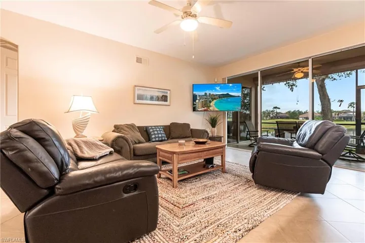 Tiled living room with expansive view of golf course