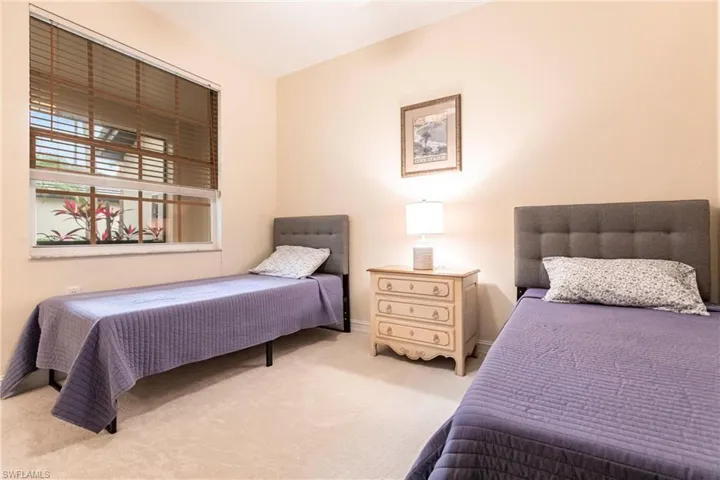 Bedroom featuring light carpet