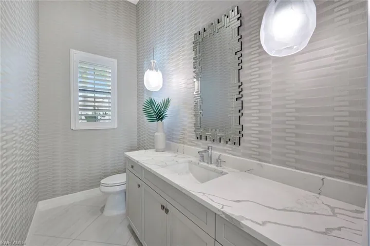 Large Powder Room featuring toilet and vanity