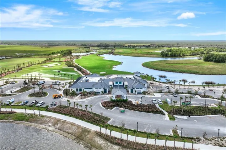 Drone / aerial view of the New Clubhouse featuring a water view