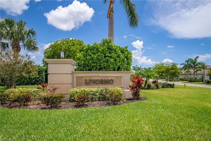 Community / neighborhood sign featuring a lawn