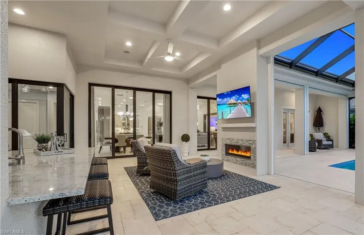 View of patio / terrace with ceiling fan, a lanai, and french doors