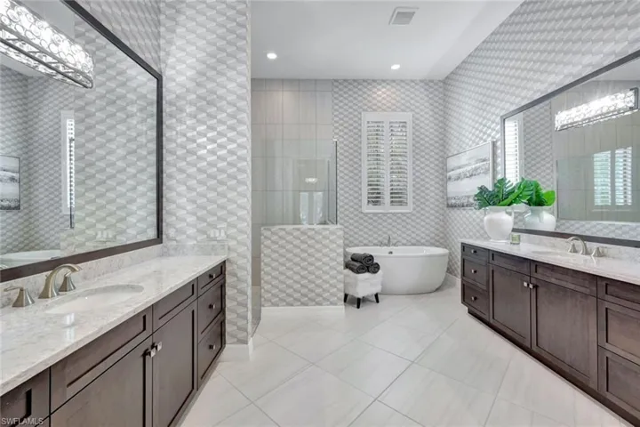 Bathroom with vanity, shower with separate bathtub, and tile patterned floors