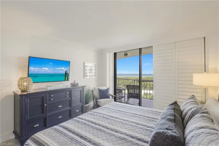 Bedroom with access to outside and ornamental molding