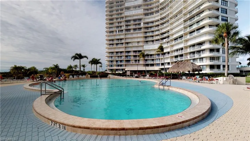 Community pool with a patio