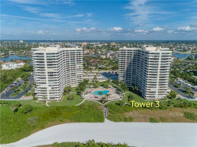 Aerial view of apartment complex and a large body of water