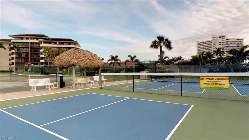 View of tennis court with a gazebo
