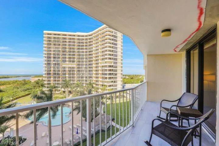Balcony featuring view of pool