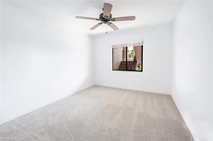 Unfurnished room with light colored carpet and ceiling fan