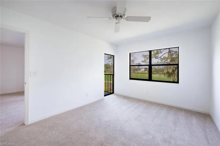 Spare room with baseboards, light colored carpet, and ceiling fan