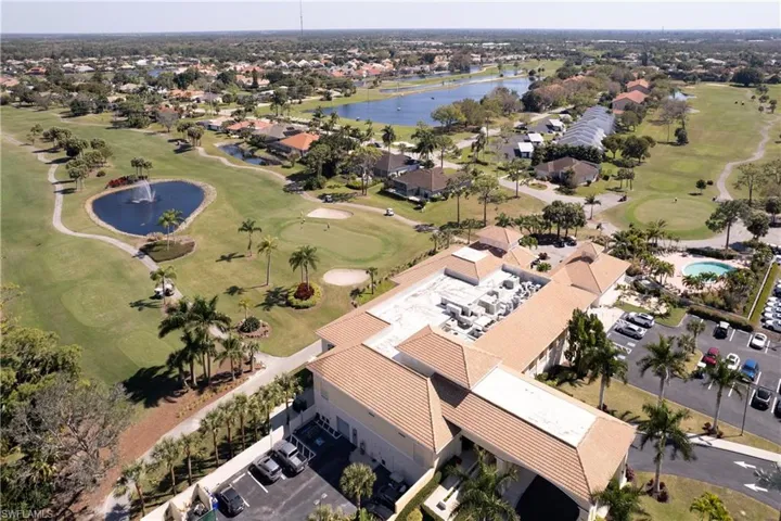 Drone / aerial view with a water view and golf course view