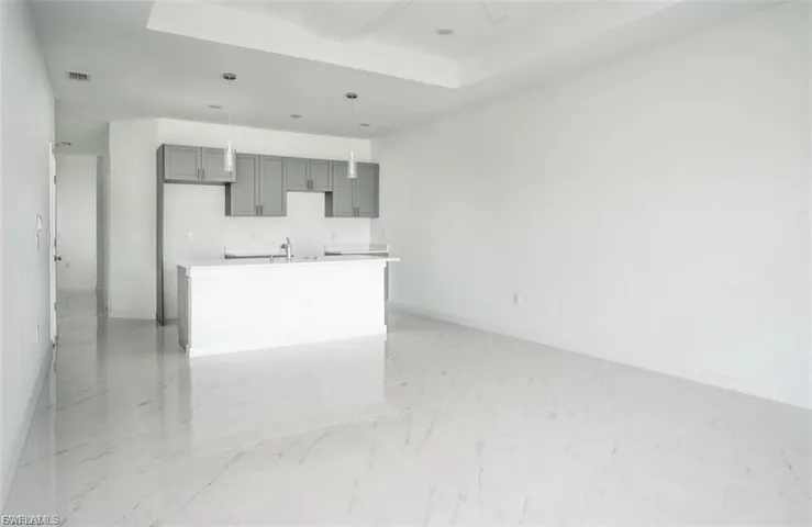 Unfurnished living room with light marble finish flooring