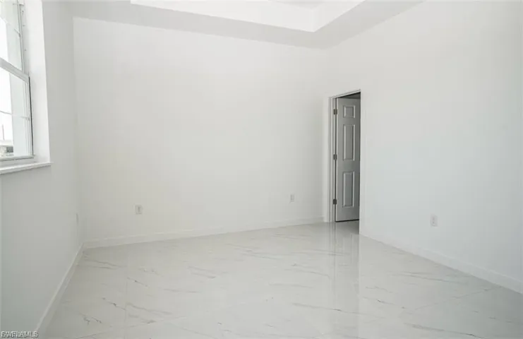 Empty room with baseboards and light marble finish floors
