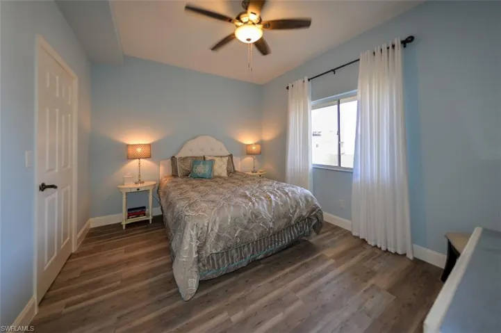 GUEST BEDROOM.  WALK-IN CLOSET ENTRANCE SHOWN AT LEFT.