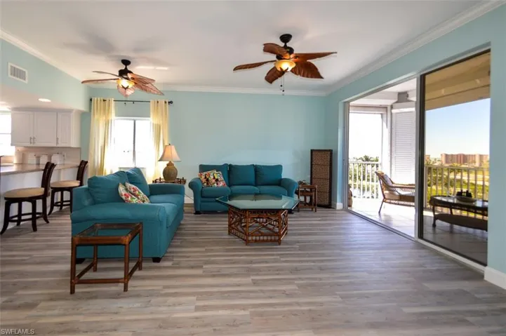 SUNNY MAIN LIVING AREA WITH WATER VIEWS.  LUXURY VINYL TILE FLOORING.  SOUTHERN AND WESTERN EXPOSURE.  CROWN MOLDING.
