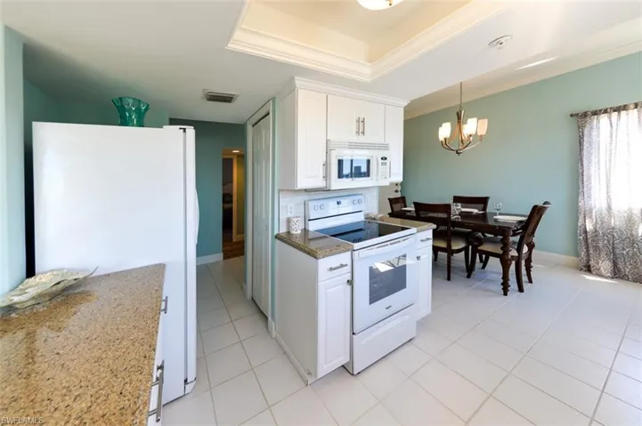 KITCHEN.  ENTRANCE TO GUEST BEDROOM AND BATH AREA SHOWN AT MIDDLE REAR.