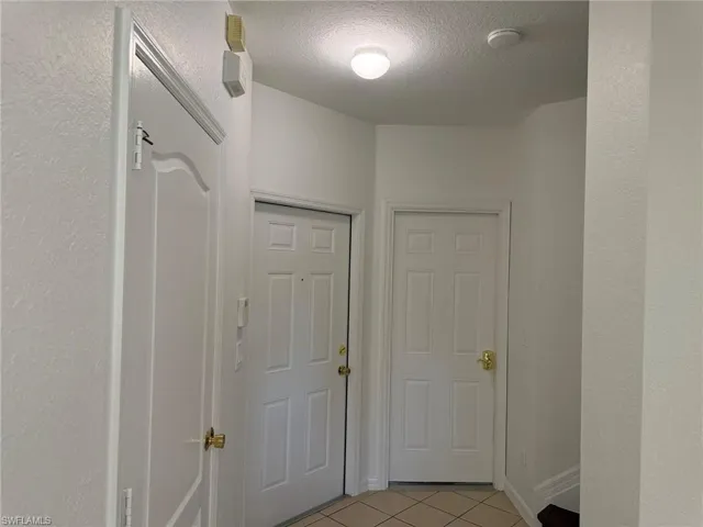 Tiled Entry Foyer. From the Right 1/s Bath, Entry Room, Door to the Garage