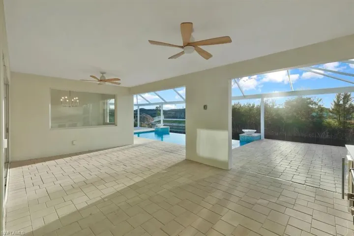 View of patio / terrace featuring ceiling fan, an outdoor pool, a sunroom, and a lanai