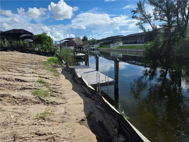 Dock area featuring a water view and a residential view