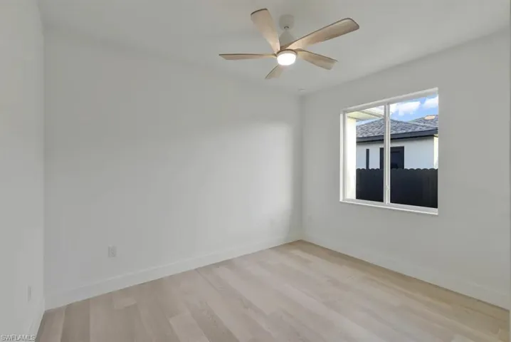 Spare room featuring light wood-style flooring and a ceiling fan