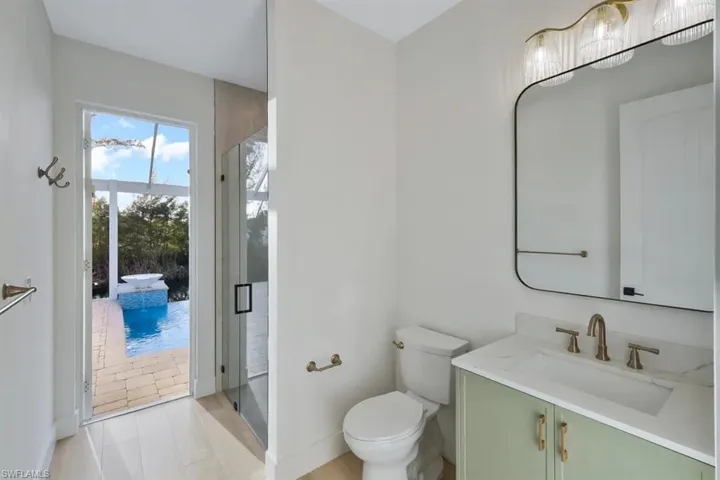 Full bathroom featuring vanity and a stall shower