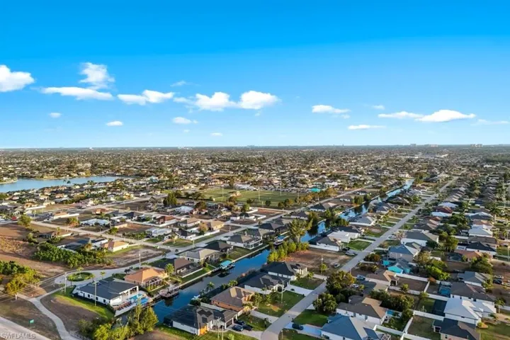 Aerial perspective of suburban area with a nearby body of water