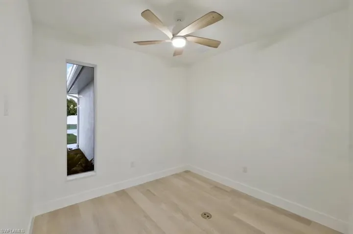 Unfurnished room with light wood-type flooring and ceiling fan