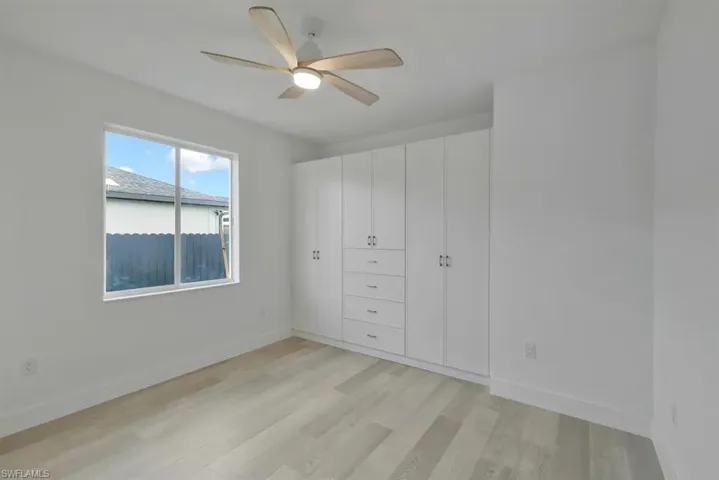 Unfurnished bedroom featuring light wood-style flooring and ceiling fan