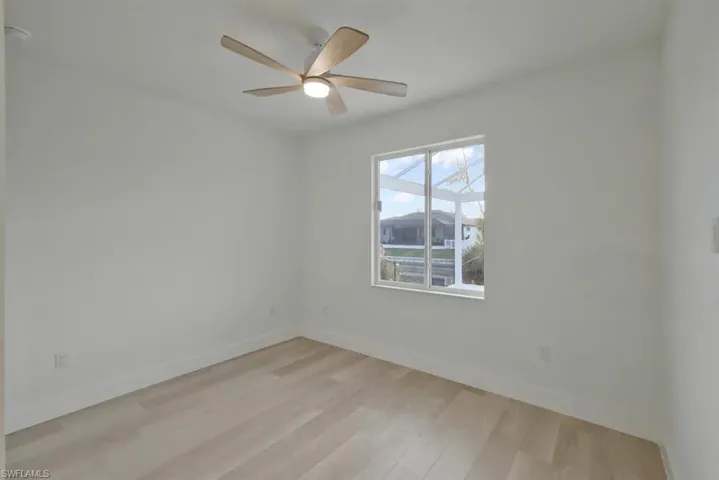 Spare room featuring light wood-style floors and a ceiling fan