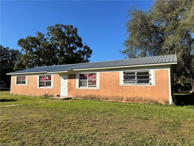 Single story home featuring a front lawn