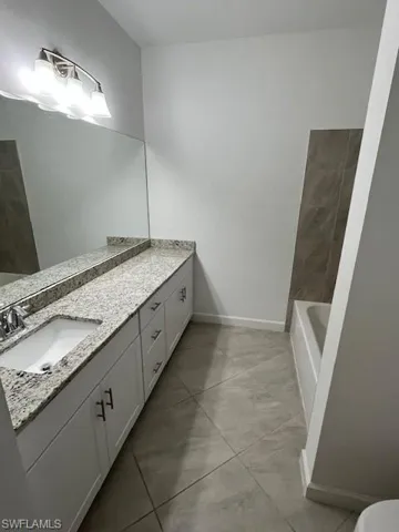 Bathroom featuring vanity and baseboards