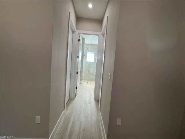 Hall with two closets and recessed lighting