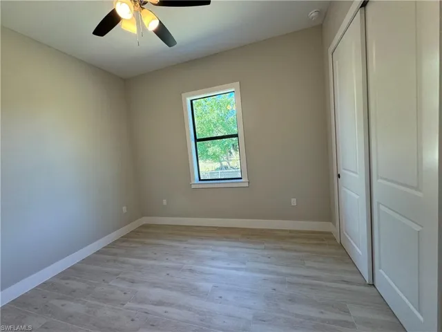 Unfurnished bedroom with a closet, and a ceiling fan.