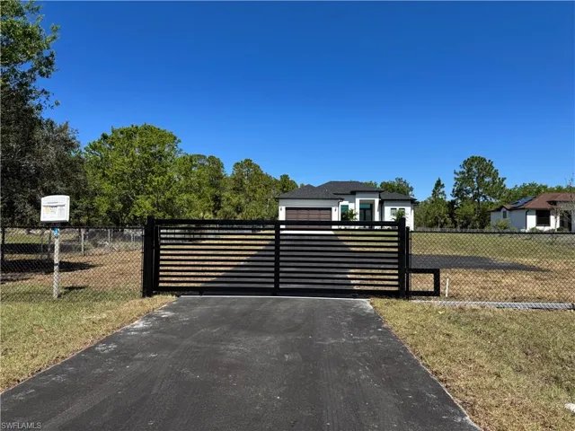 Gate featuring a fenced front yard